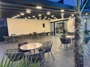 a patio with tables and chairs in a restaurant at RADINA FAMILY in Kallithea Halkidikis