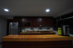 a kitchen with a wooden counter top and a refrigerator at Anita Hostal in Chachapoyas