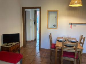 una sala da pranzo con un tavolo e una televisione di Casa Express tra Como e Milano a Saronno