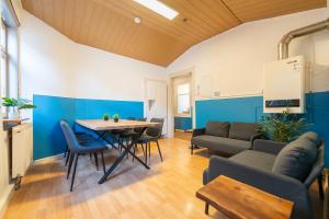 a living room with a table and a couch at City Apartment #33 - Coburg in Coburg +18 photos