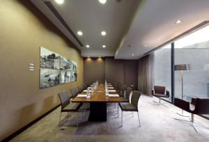 a conference room with a long table and chairs at Eurostars Das Letras in Lisbon