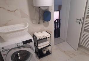 a laundry room with a washing machine in a bathroom at Studio Sofia in Rakek