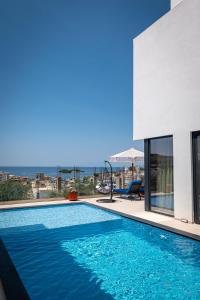 a swimming pool with a view of the ocean at Luxury Villas Angela in Ksamil