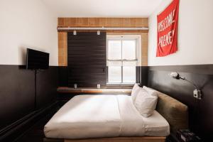a bedroom with a bed and a window at The Clyde Hotel Portland By Kasa Living in Portland