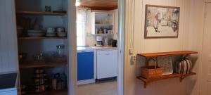 a kitchen with a stove and a white refrigerator at Månsarps skogs- och alpackagård in Vimmerby