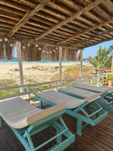 a picnic table and chairs on the beach at Lehani Beach Hostel in Praia do Tofo