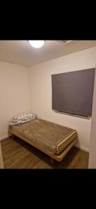 a bed in a room with a flat screen tv at Nydelig leilighet til leie in Halden