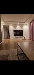 a large living room with a large flat screen tv at Nydelig leilighet til leie in Halden