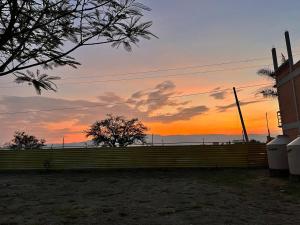 a sunset over a fence in front of a house at Hotel Senda del Ángel in Zorita