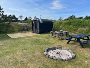 a black trailer with a picnic table and a picnic bench at Stone MT Garden Pod in Snedsted +4 photos