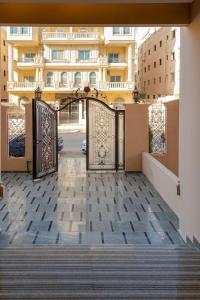 an entrance to a building with two gates at Settle Inn South 90 Apartments in Cairo