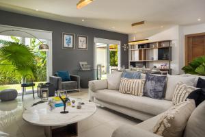 a living room with a couch and a table at Beachfront 3BD Luxury Villa with full hotel access in Cabarete