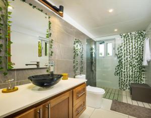 a bathroom with a sink and a shower at Beachfront 3BD Luxury Villa with full hotel access in Cabarete +12 photos