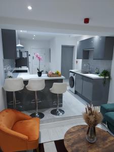 a kitchen and living room with a table and chairs at OnPoint Home in Coventry