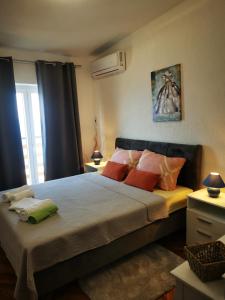 a bedroom with a large bed with colorful pillows at Apartment Ana in Senj