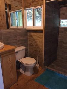 a small bathroom with a toilet and a shower at Mango House Detox studio in Cabarete