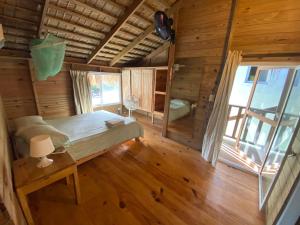 a bedroom with a bed in a wooden cabin at Mango House Detox studio in Cabarete