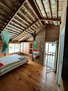 a bedroom with a bed in a wooden house at Mango House Detox studio in Cabarete