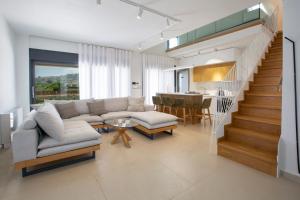 a living room with a couch and a table at Aquamarina Villas in Lefkada Town