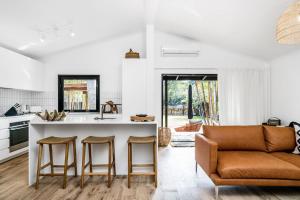 a kitchen and living room with a counter and a couch at 3 Salty Sisters in Byron Bay