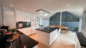 a kitchen and dining room with a table in it at Panorama #CasaSolvik #Loen in Loen