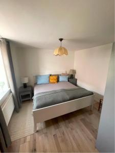 a bedroom with a bed with blue and orange pillows at Ferienwohnung Hof Schacht in Penkow +10 photos