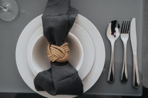 a plate with a black tie sitting on a table at Large cosy house - free on street parking in Liverpool +42 photos