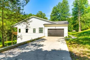 a white house with a garage at Sleek Tennessee Retreat 2 Mi to Center Hill Lake! in Lancaster