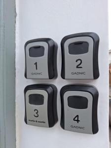 four black knobs on a white door at Casa Alba in San Salvador de Jujuy