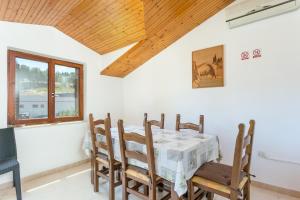 a dining room with a table and chairs at Apartments with parking space Supetar, Brac - 5670 in Supetar