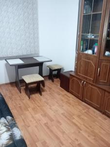 a room with a table and two chairs and a cabinet at Garsoniera Adriana in Băile Herculane