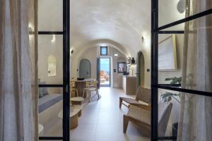 a hallway with a living room and a dining room at Annouso Villa with Hot Tub by Caldera Houses in Oia