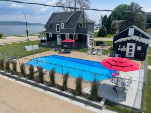 a house with a swimming pool in front of a house at Single King Room in Lake City
