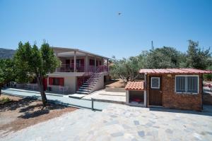 a house with a staircase and a building at Oregano peaceful complex in Porto Rafti
