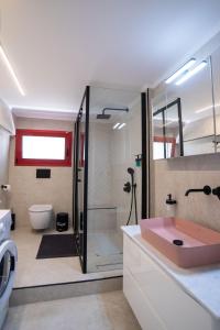 a bathroom with a shower and a pink sink at Oregano peaceful complex in Porto Rafti +52 photos