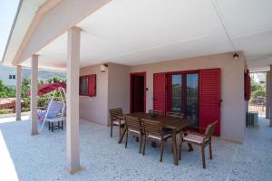 a wooden table and chairs on a patio at Oregano peaceful complex in Porto Rafti