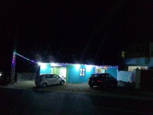 a house with two cars parked in a parking lot at night at Zia Guest House in Gilgit