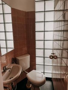 a bathroom with a toilet and a sink at Wohnen im Ländereck! Essen-Mülheim-Oberhausen! BS2L in Essen