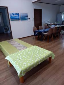 a room with two beds and a table and chairs at いやさかyani in Yani