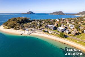 una vista aerea di una spiaggia con un resort di Bay Parklands, 22, 2 Gowrie Avenue - pool, tennis court, spa, child friendly a Nelson Bay