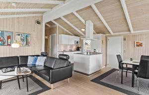 a living room with a couch and a kitchen at Holiday Home Kragevej in Hirtshals