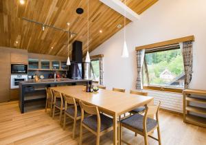 a kitchen and dining room with a wooden table and chairs at NISEKO REISE HOUSE ニセコライゼハウス in Kutchan