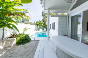 a home with a swimming pool in the backyard at La Casa Byron in Byron Bay