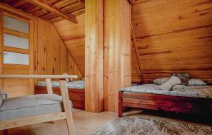 a bedroom with two beds in a wooden cabin at Holiday Home Ostróda Rus Mala Ii in Ostróda