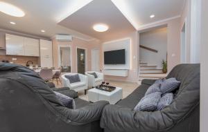 a living room with a couch and a tv at Amazing Home In Zadar With Wifi in Zadar