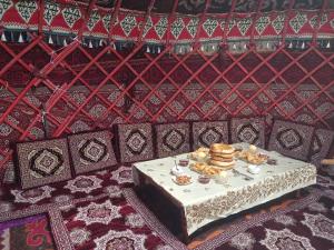 a table with food on it in a room at Nice Yurt Camp in Sary-Mogul