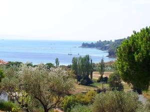 a view of the ocean from a hill with trees at Villa Anna Maria in Agia Paraskevi