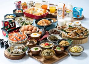 a table topped with lots of different types of food at Vessel Hotel Kumamoto Airport in Ozu