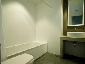 a bathroom with a toilet and a sink at DI Place in Bangkok