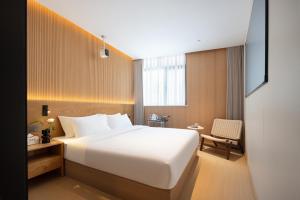 Shanghai Captain 5 Youth Hotel - Xinzhuang Metro Station 객실 침대